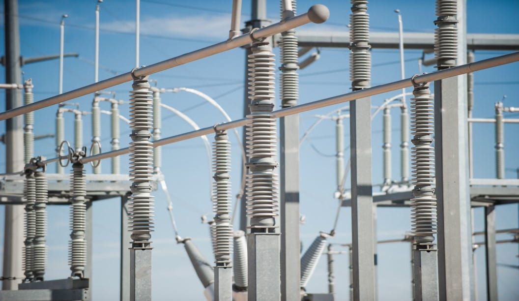 Electrical substation with insulator and power lines.