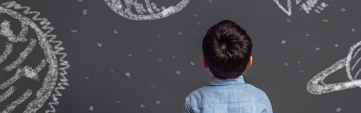 Young child looking at chalkboard