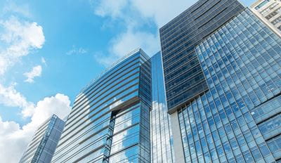 A skyline view featuring sleek, modern office buildings in an urban setting
