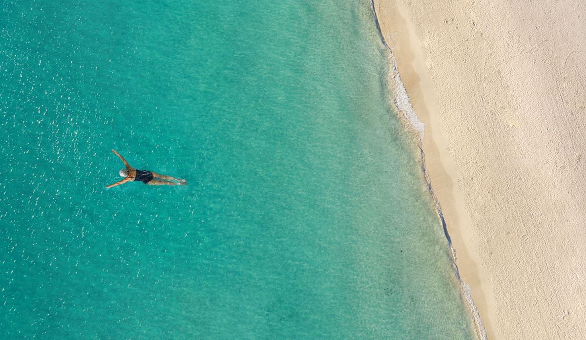 Snorkeler in tropical waters from above