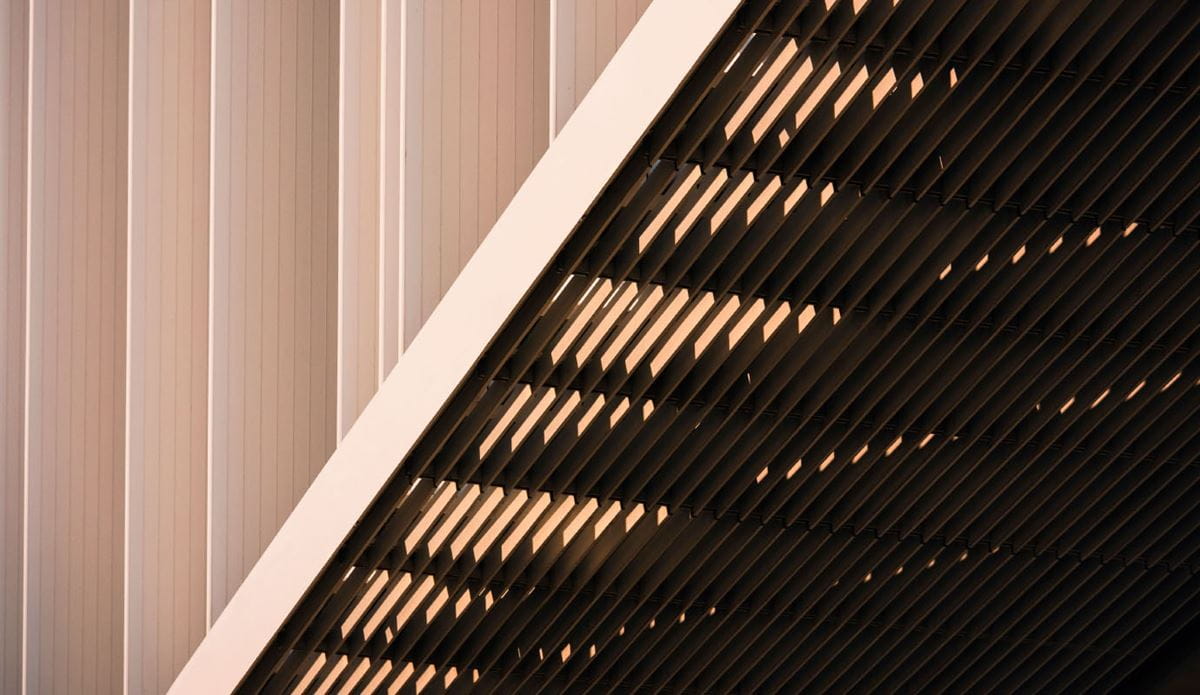 Abstract architectural facade with diagonal slats and vertical panels.