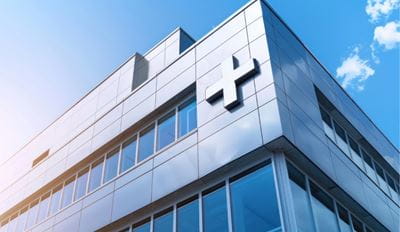 Office building with plus sign