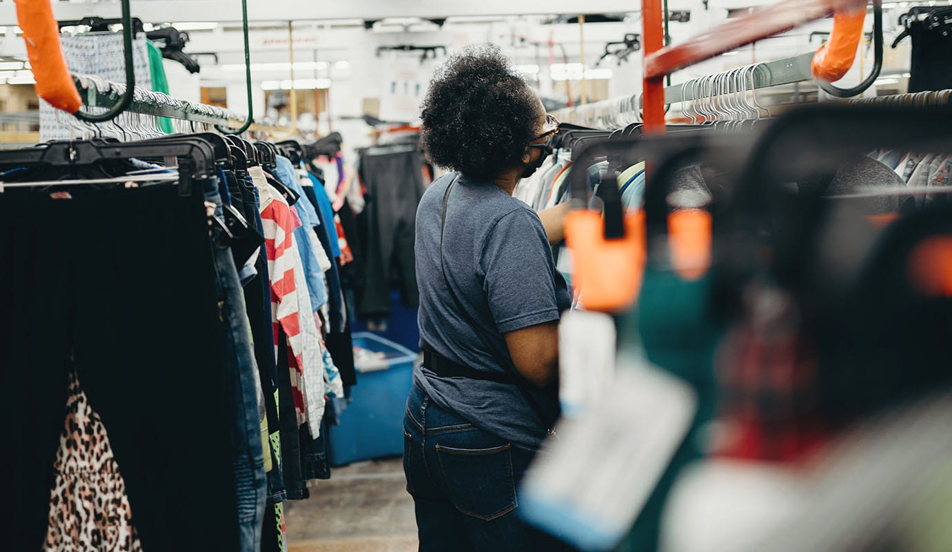 An Indian woman stands in front of solar panels