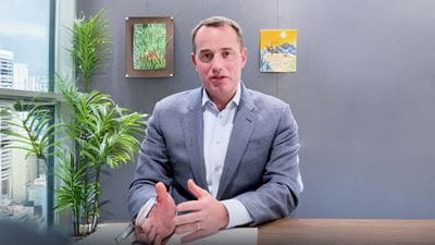 A man dressed in a suit is working at a desk
