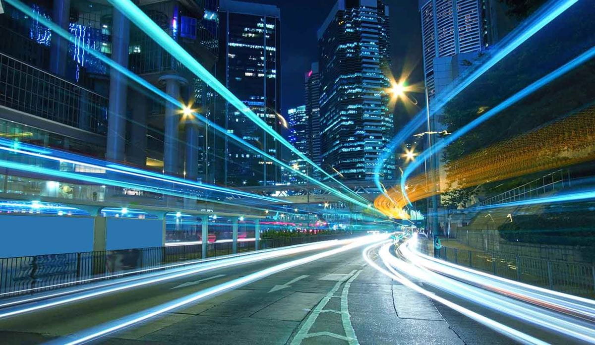 Highway with high rise buildings at night