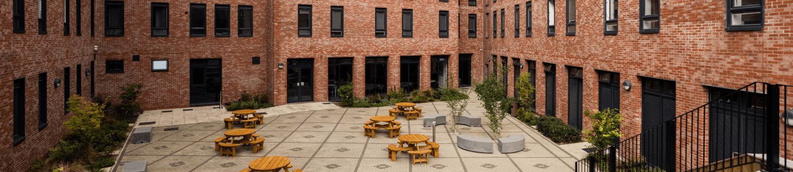 Brown buildings with the wooden tables and chairs