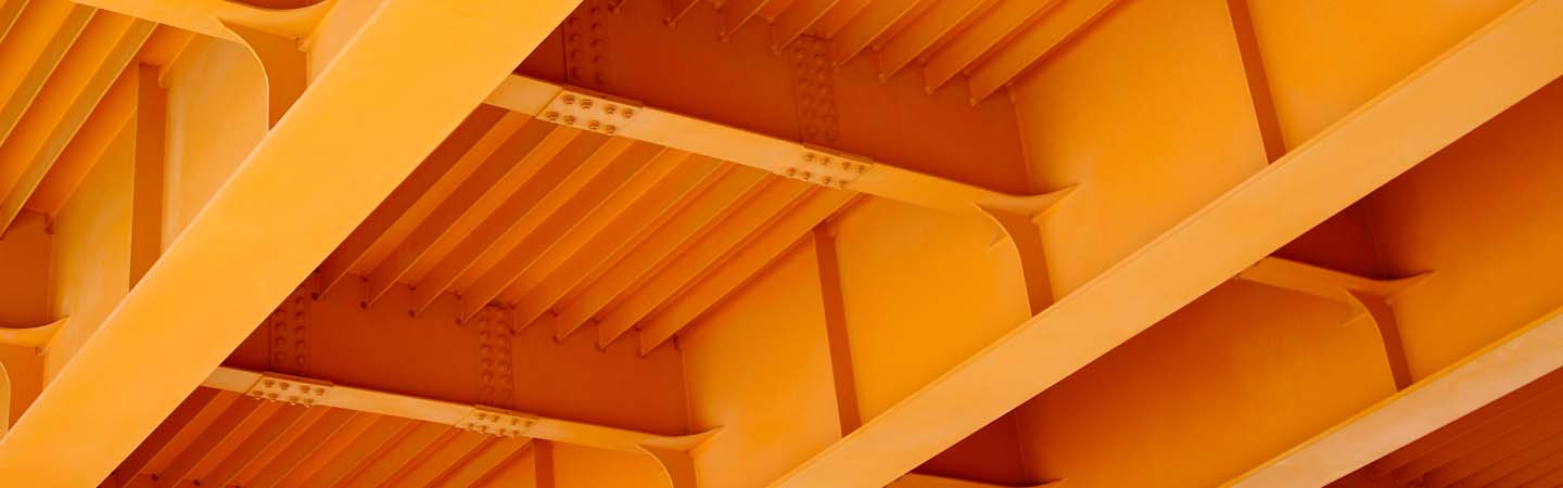 View of a bridge's underside showcasing multiple orange beams