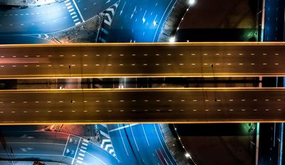 Drone view of an empty highway overpass at night